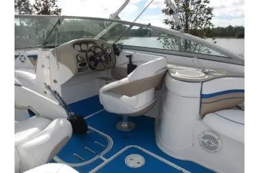 Slide: The Image of 2005 Four Winns 190 Horizon boat interior with blue flooring and white seating. - 4
