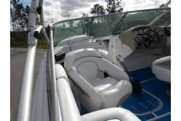 Slide: The Image of 2005 Four Winns 190 Horizon boat interior with white seating and blue flooring. - 5