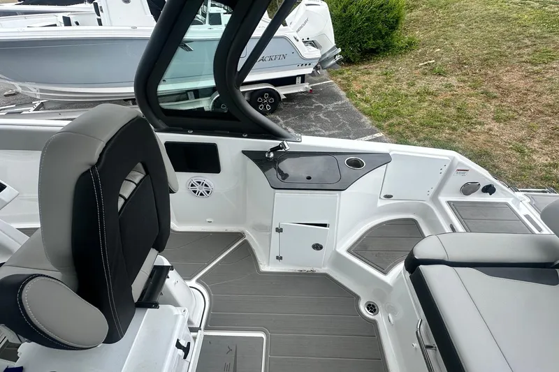 Slide: The Image of 2026 Monterey Elite 25 OB boat interior with seating and control panel. - 14