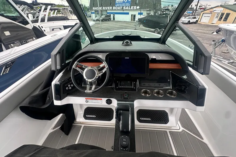 Slide: The Image of 2026 Monterey Elite 25 OB boat dashboard with modern steering and control panel. - 15