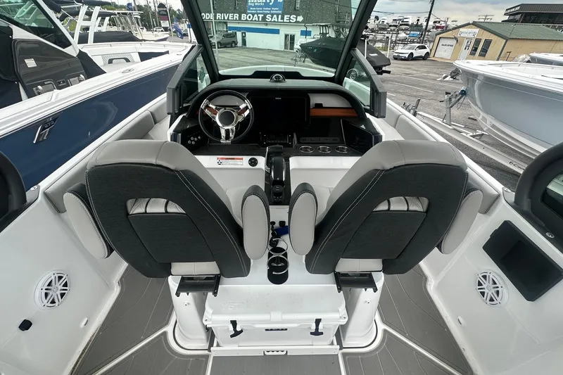 Slide: The Image of Interior view of 2026 Monterey Elite 25 OB boat with dual seats and modern dashboard. - 16