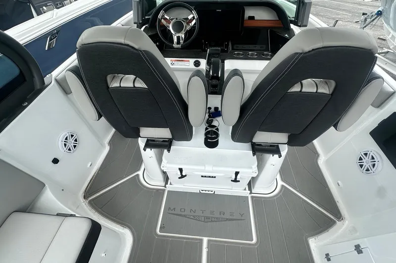 Slide: The Image of Interior of 2026 Monterey Elite 25 OB boat with dual seats and modern dashboard. - 18