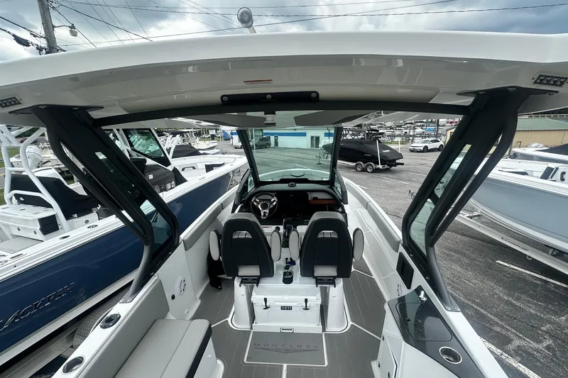 Slide: The Image of 2026 Monterey Elite 25 OB boat interior with modern seating and sleek design. - 20