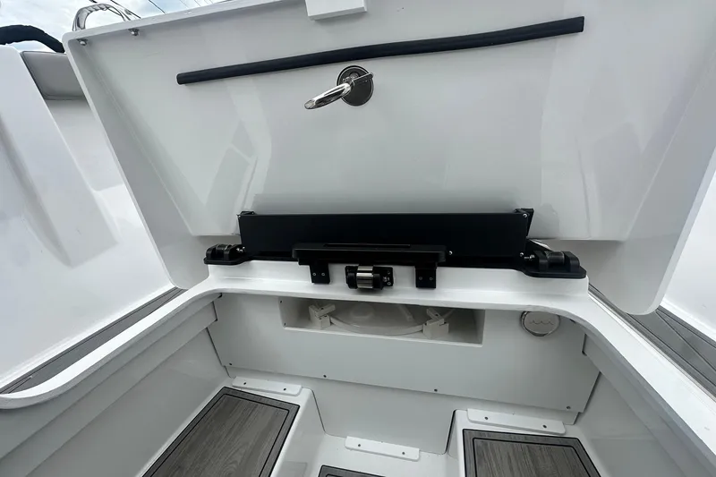 Slide: The Image of Storage compartment of 2026 Monterey Elite 25 OB boat, featuring sleek design and secure latch. - 25