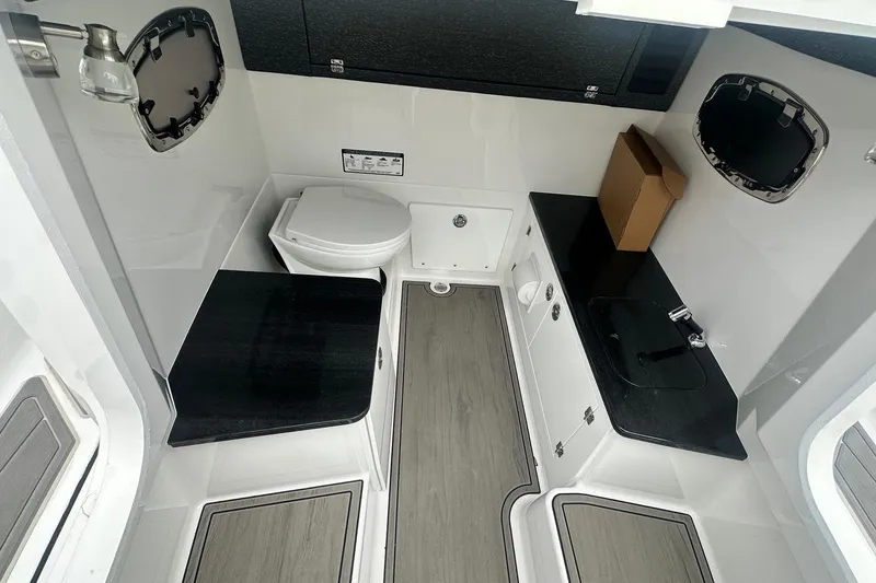 Slide: The Image of 2026 Monterey Elite 25 OB boat interior with modern bathroom amenities. - 26
