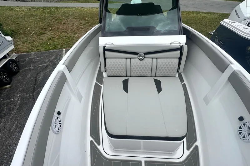 Slide: The Image of 2026 Monterey Elite 25 OB boat interior with cushioned seating and modern design. - 28