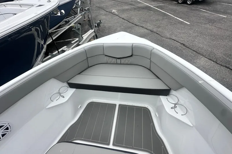 Slide: The Image of 2026 Monterey Elite 25 OB boat interior with gray seating and cup holders. - 30