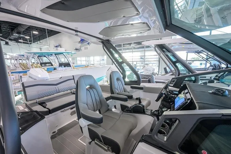 Slide: The Image of Interior of 2026 Monterey Elite 25 OB boat with modern seating and dashboard. - 7