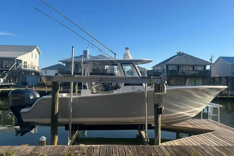 The Image of 2022 Sportsman Open 282TE Center Console boat docked at a marina. - 0