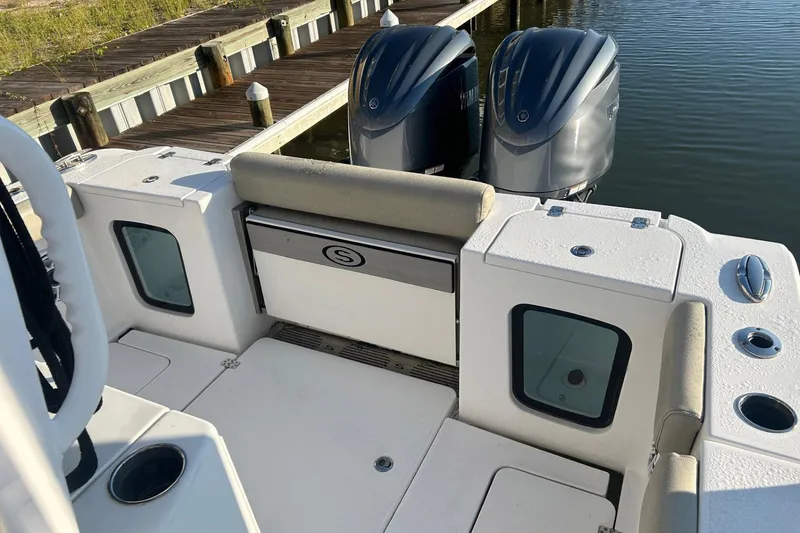Slide: The Image of 2022 Sportsman Open 282TE Center Console boat with twin engines at dock. - 3