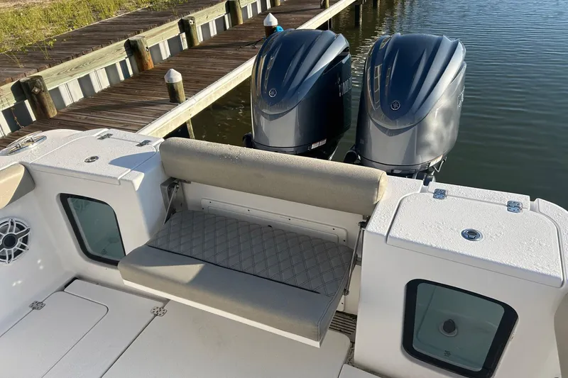 Slide: The Image of 2022 Sportsman Open 282TE Center Console with dual outboard motors at dock. - 4