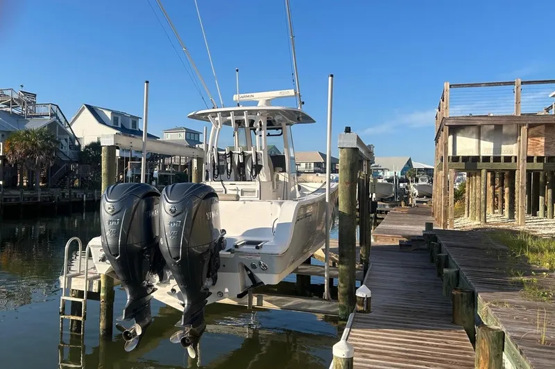 Slide: The Image of 2022 Sportsman Open 282TE Center Console boat docked in a marina. - 5