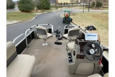 Slide: The Image of 2020 Sun Tracker Bass Buggy 18 DLX pontoon boat interior with seating and steering console. - 10