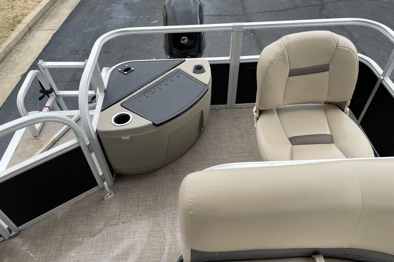 Slide: The Image of 2020 Sun Tracker Bass Buggy 18 DLX pontoon boat interior with beige seating and console. - 12