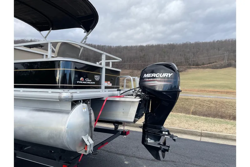 Slide: The Image of 2020 Sun Tracker Bass Buggy 18 DLX with Mercury outboard motor on trailer. - 4