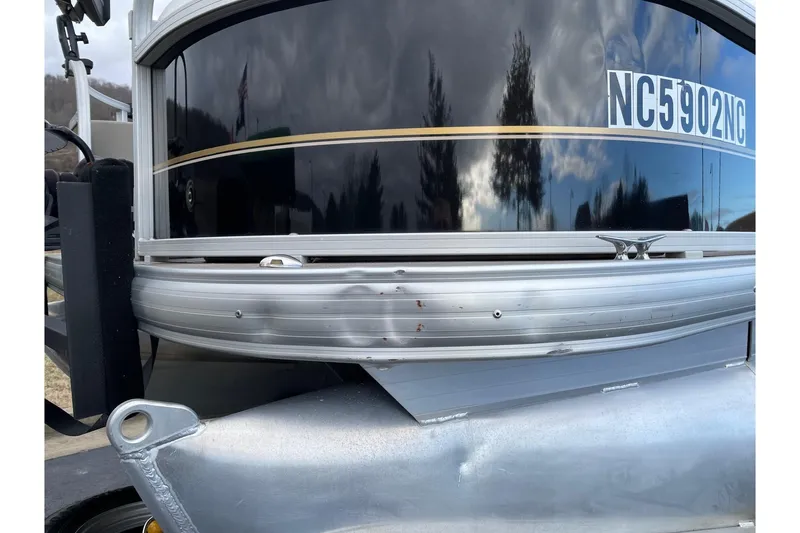 Slide: The Image of 2020 Sun Tracker Bass Buggy 18 DLX pontoon boat with visible exterior damage. - 5