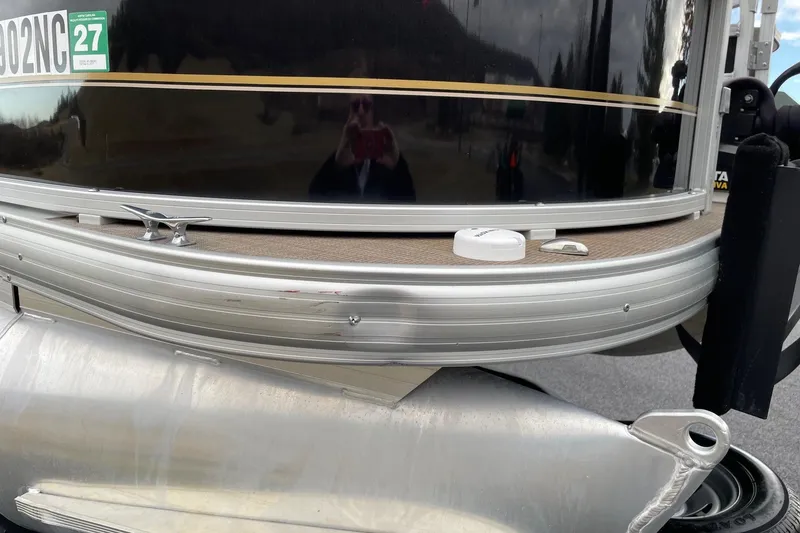 Slide: The Image of 2020 Sun Tracker Bass Buggy 18 DLX pontoon boat with visible exterior damage. - 6