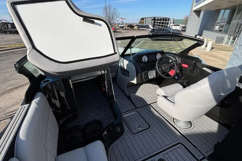 Slide: The Image of 2026 MB B52 23 Classic boat interior with open storage, modern dashboard, and seating. - 15