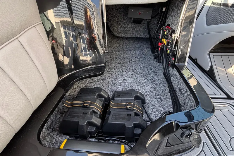 Slide: The Image of Interior view of 2026 MB B52 23 Classic boat showing battery compartment and wiring. - 16