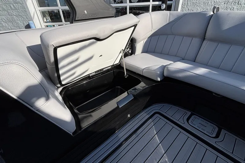 Slide: The Image of 2026 MB B52 23 Classic boat interior with open storage compartment and gray seating. - 17