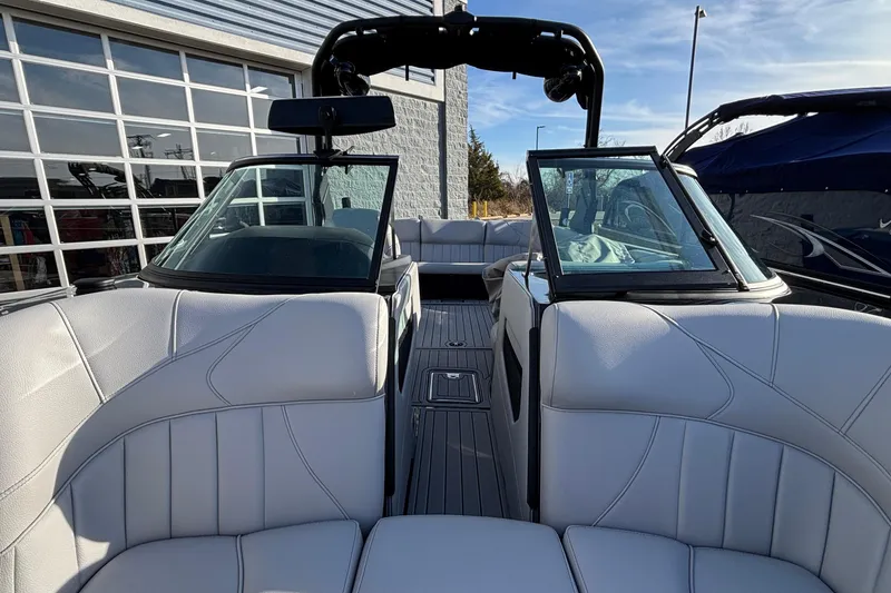 Slide: The Image of 2026 MB B52 23 Classic boat interior with white seating and open windshield. - 30