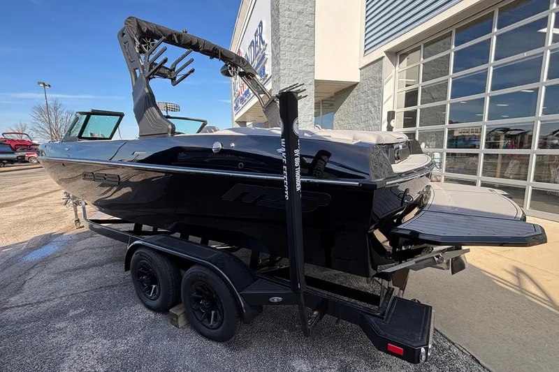 Slide: The Image of 2026 MB B52 23 Classic boat on trailer, parked outside a building. - 35