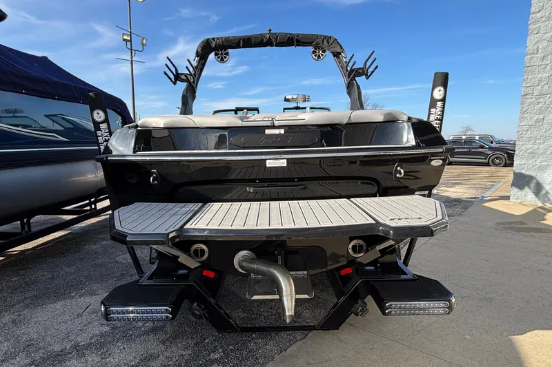 Slide: The Image of 2026 MB B52 23 Classic boat, rear view, showcasing sleek design and swim platform. - 4