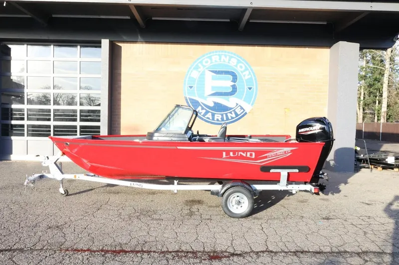 The Image of 2026 Lund 1650 Angler Sport boat in red on trailer at Johnson Marine. - 1