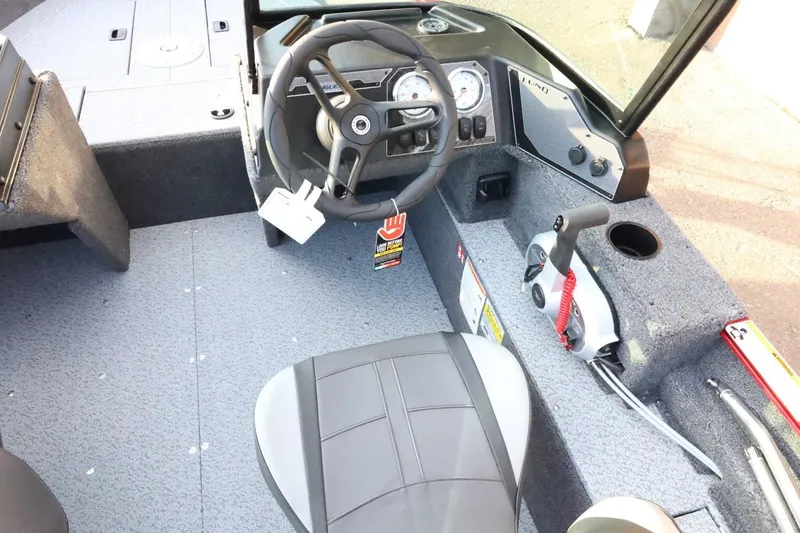 Slide: The Image of Interior of 2026 Lund 1650 Angler Sport boat with steering wheel and controls. - 10