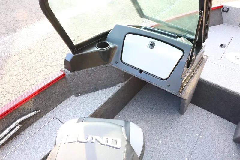 Slide: The Image of 2026 Lund 1650 Angler Sport boat interior with windshield and storage compartment. - 11