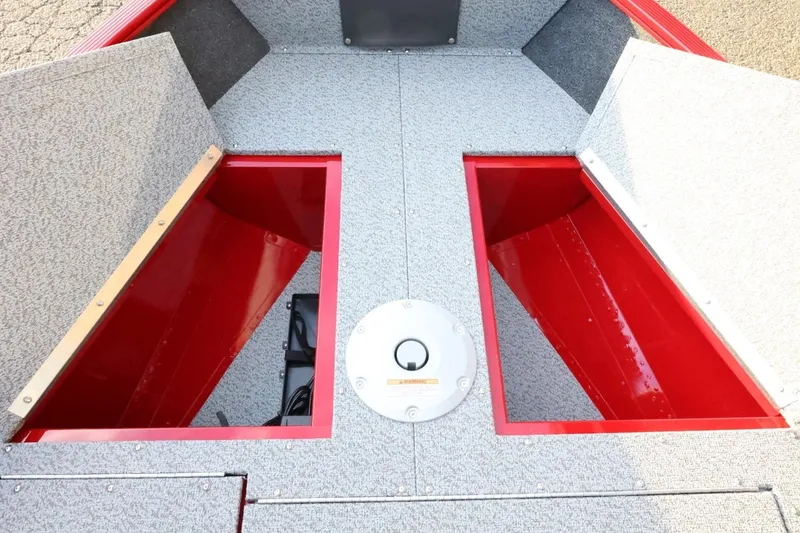 Slide: The Image of 2026 Lund 1650 Angler Sport boat interior storage compartments, red and gray design. - 14