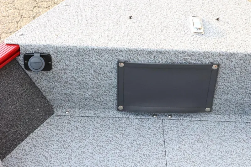 Slide: The Image of Interior view of 2026 Lund 1650 Angler Sport boat, featuring textured flooring and storage compartment. - 15