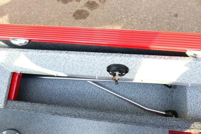 Slide: The Image of 2026 Lund 1650 Angler Sport boat interior with red accents and storage compartment. - 19