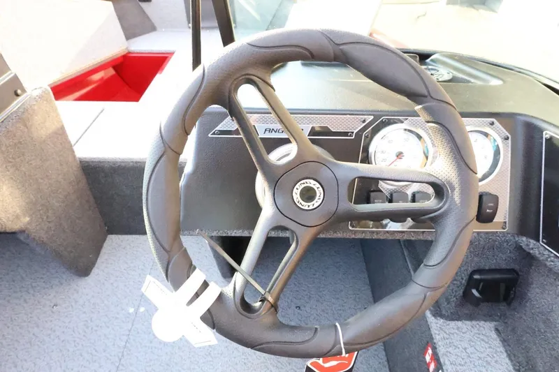 Slide: The Image of Steering wheel of 2026 Lund 1650 Angler Sport boat with dashboard gauges. - 22