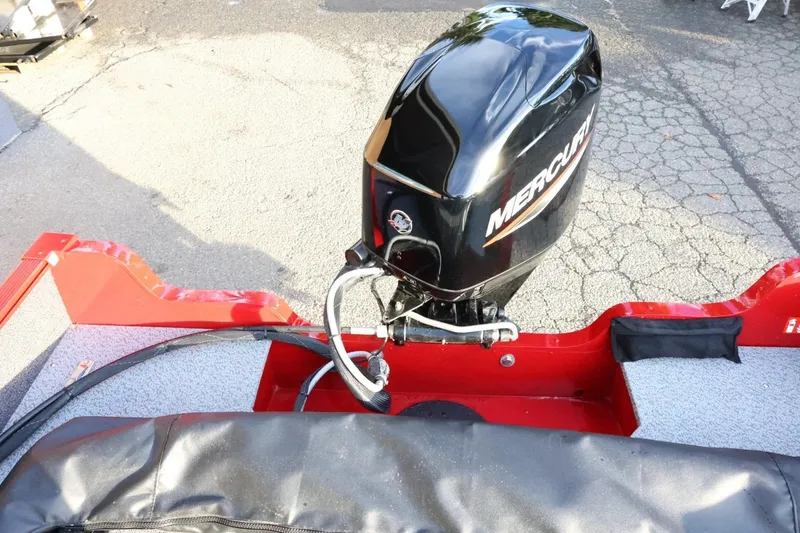 Slide: The Image of 2026 Lund 1650 Angler Sport boat with Mercury outboard motor, red interior. - 24