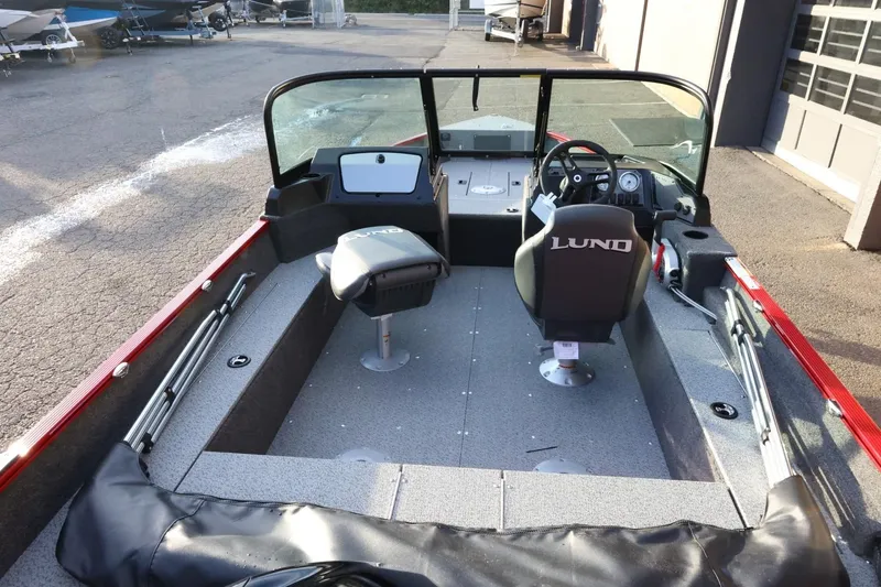 Slide: The Image of 2026 Lund 1650 Angler Sport boat interior with dual seats and steering console. - 8