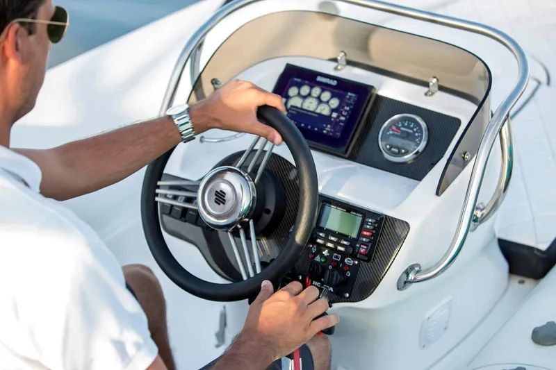 Slide: The Image of Manufacturer Provided Image: 2018 Walker Bay Generation 525 DLX boat dashboard with steering wheel and control panel. - 13