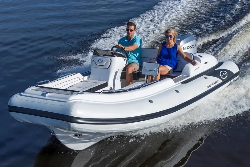 Slide: The Image of Manufacturer Provided Image: 2018 Walker Bay Generation 525 DLX boat cruising on water with two passengers. - 5