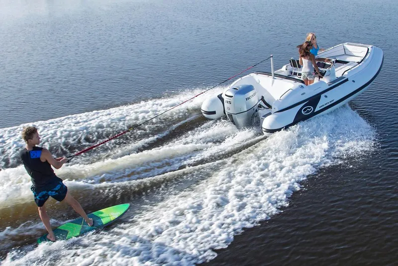 Slide: The Image of Manufacturer Provided Image: 2018 Walker Bay Generation 525 DLX towing a wakeboarder on a lake. - 9