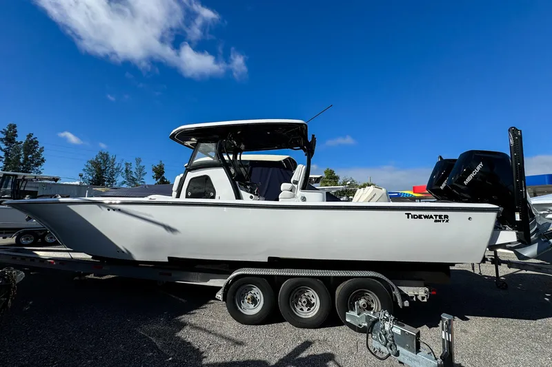 The Image of 2026 Tidewater 3100 Carolina Bay boat on trailer under clear blue sky. - 0