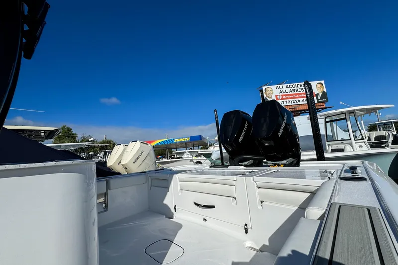 Slide: The Image of 2026 Tidewater 3100 Carolina Bay boat with dual Mercury engines under clear blue sky. - 25
