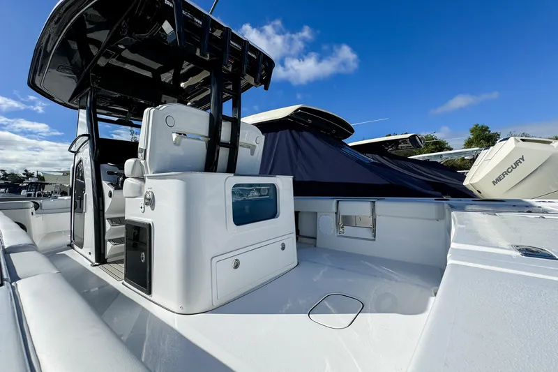 Slide: The Image of 2026 Tidewater 3100 Carolina Bay boat with sleek design and modern features under a clear sky. - 26