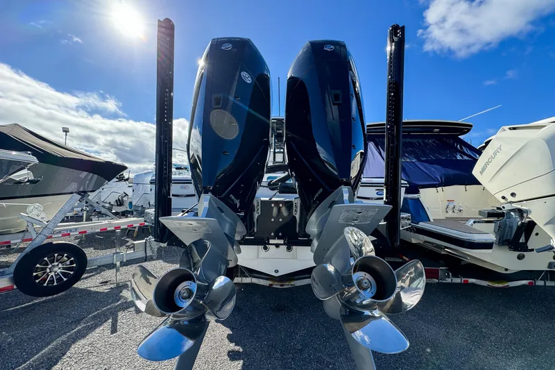 Slide: The Image of 2026 Tidewater 3100 Carolina Bay boat with dual outboard motors in a sunny marina. - 3