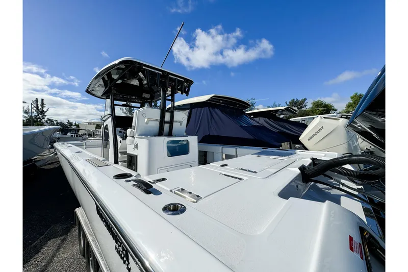 Slide: The Image of 2026 Tidewater 3100 Carolina Bay boat with sleek design under clear blue sky. - 30