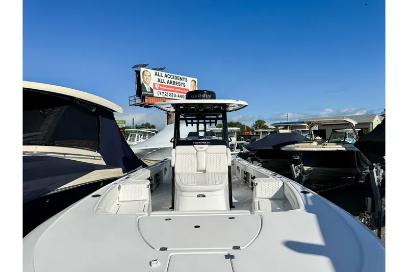 Slide: The Image of 2026 Tidewater 3100 Carolina Bay boat displayed at a marina under clear blue skies. - 5