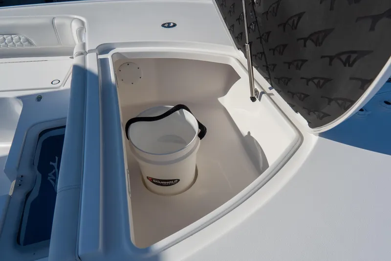 Slide: The Image of 2026 Tidewater 3100 Carolina Bay boat storage compartment with bucket inside. - 6