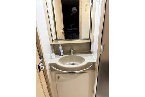 Slide: The Image of 1997 Bayliner 3788 Command Bridge Motoryacht helm with steering wheel and control panel. - 13