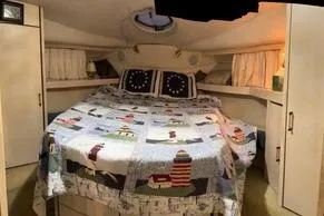 Slide: The Image of Cozy bedroom in 1997 Bayliner 3788 Command Bridge Motoryacht with nautical-themed bedding. - 15