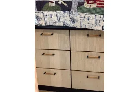 Slide: The Image of 1997 Bayliner 3788 Command Bridge Motoryacht interior with wooden drawers and quilted bedspread. - 16