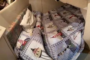 Slide: The Image of 1997 Bayliner 3788 Command Bridge Motoryacht cabin with nautical-themed bedding. - 20